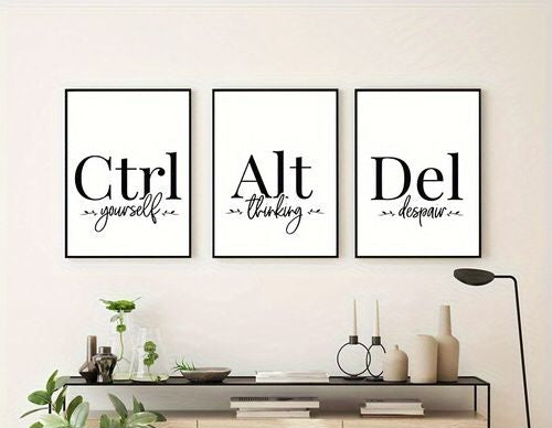 Three framed wall art prints with black typography on white backgrounds hang above a console table. The words read 'Ctrl yourself', 'Alt thinking', and 'Del despair'.