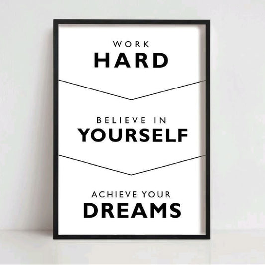 A framed motivational poster with black text on a white background, reading 'WORK HARD BELIEVE IN YOURSELF ACHIEVE YOUR DREAMS,' shown leaning against a light wall. The name 'OZIL KHAN' appears above the frame.